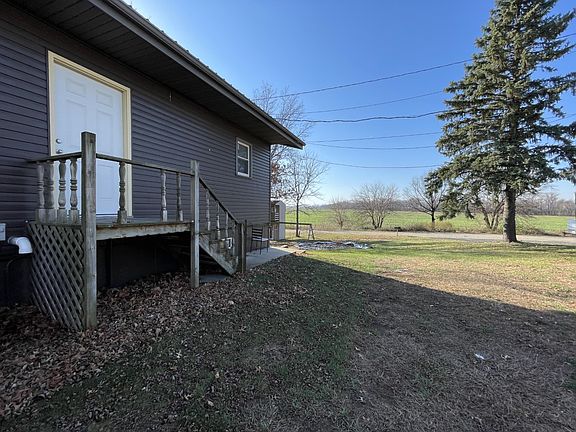 The building has two apartments. The door opens to an entryway leading to the apartment doors.