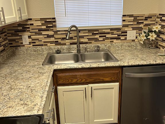 Kitchen includes view to front of unit, Electric stove, Dishwasher, and Refrigerator.