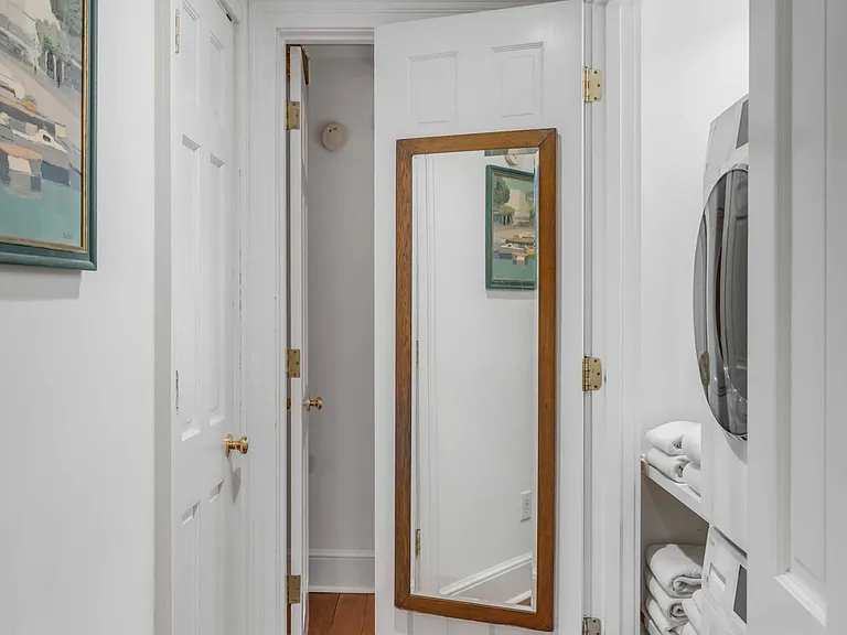 Third floor hallway looking left from landing to guest bedroom/ laundry station.