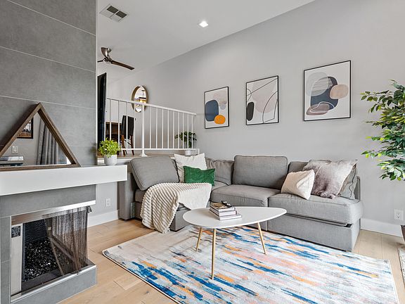 Step into a realm of modern elegance in this living room, where sophistication meets comfort in perfect harmony.