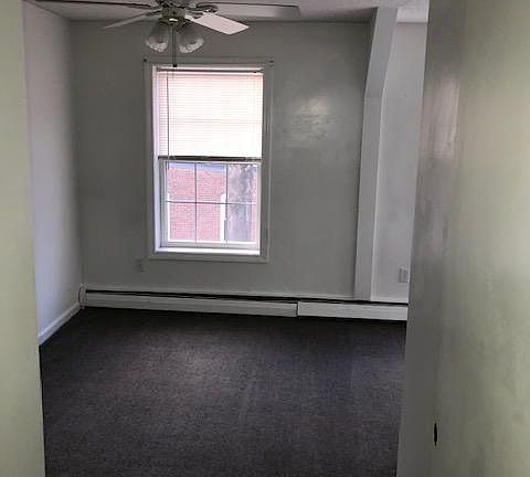 Small bedroom which can support a queen size bed w/ closet and w/w carpeting.