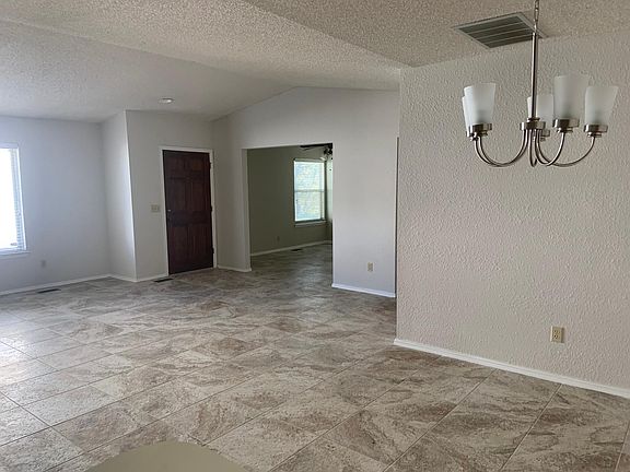 View from kitchen looking at living room, front door and study/office