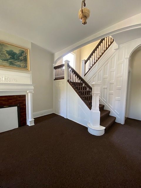 Main entry with original woodwork and fireplace