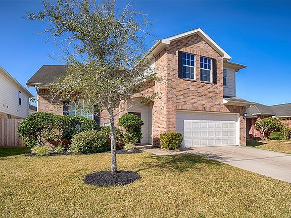 Lush landscaping runs along the front of the home.