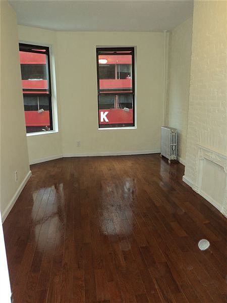 bedroom 1 with new 3/4" hardwood floors in front of apartmen