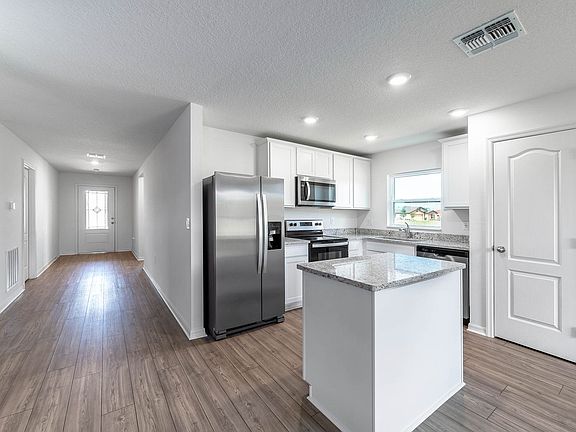 The long foyer leads you to a open concept family room and kitchen