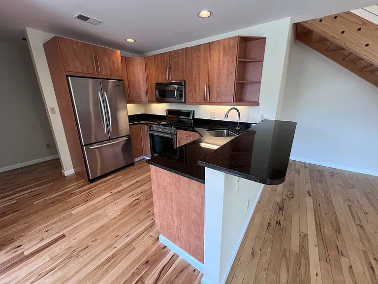 Kitchen with high-end appliances and tons of storage. Additional bar seating.
