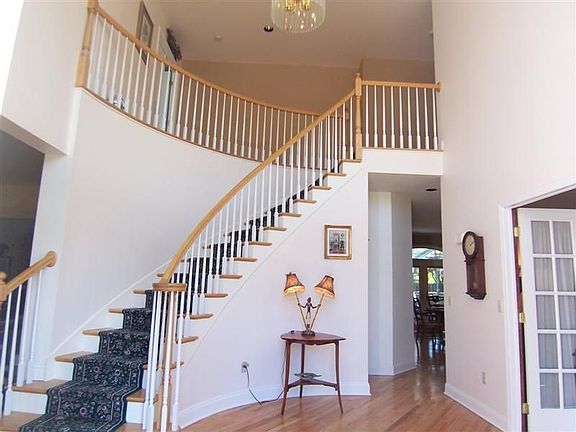 Soaring foyer welcomes you and boasts a graceful circular staircase