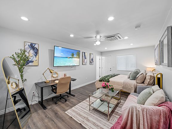 This living room offers a balance of elegance and comfort with curated decor, cozy seating, and lots of natural light.