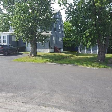Property sits on a corner lot. View of the building and garages from the side street off Warwick Avenue.