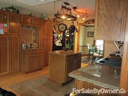 Kitchen with island and hanging light for pots and pans