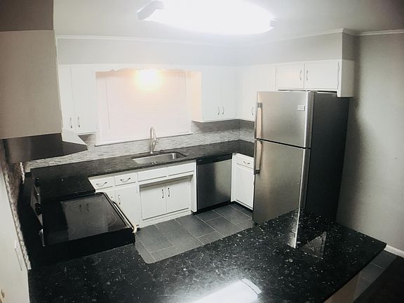 Kitchen with granite and stainless steel appliances.