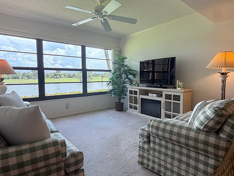 Cozy up to STUNNING lake & golf course views from the living area!