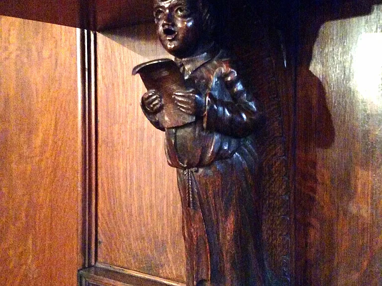 Hand carved figures on fireplace mantle