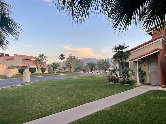 Looking at the pool and tennis courts in the distance to the right of the condo