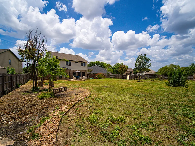 The lot fans out into a massive, private 0.31-acre yard_nearly double the size of standard subdivision lots. It provides unparalleled space for entertaining, sprawling patios, or creating your own backyard oasis with room to spare.
