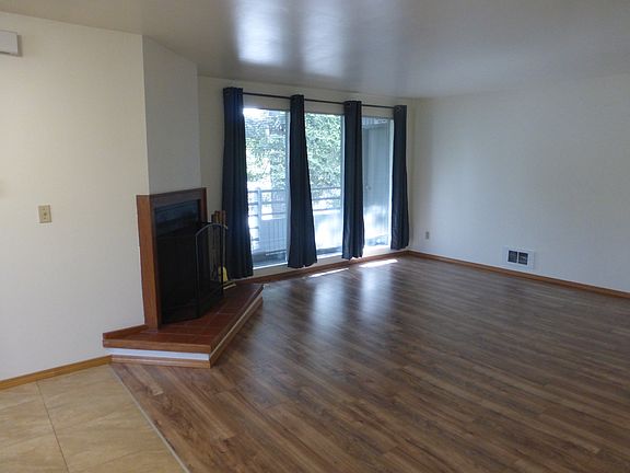 Floor to ceiling windows bring light in to living area.