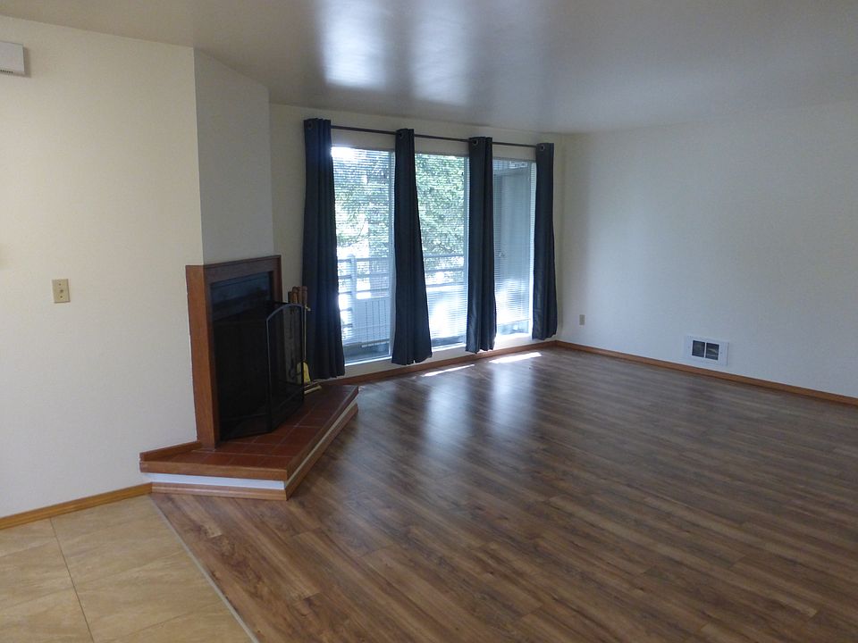 Floor to ceiling windows bring light in to living area.
