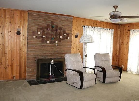Spacious living area with woodburning fireplace.  Great windows for lots of light.