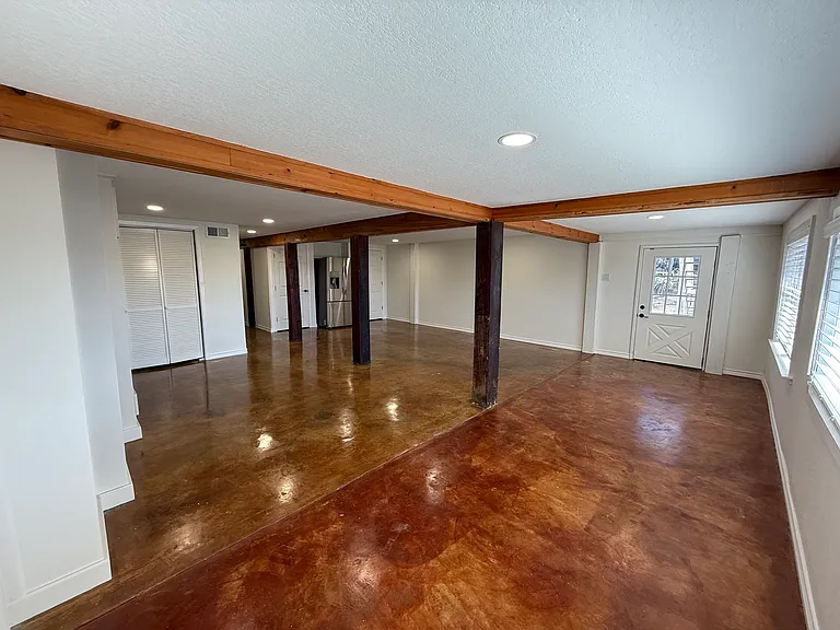 Large Family Room with Built-In Bookshelves and Laundry Room