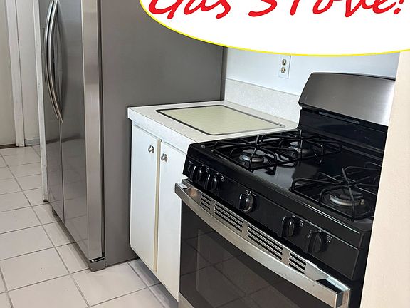 Gast Stove! 
Galley kitchen with stainless steel appliances including dishwasher