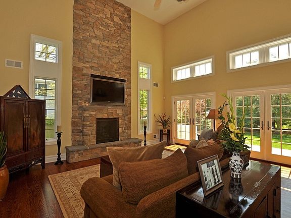 Two story great room with stone fireplace
