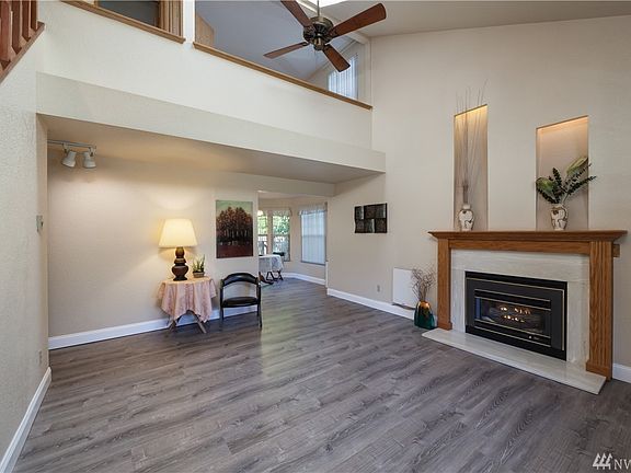 Living room has vaulted ceiling & gas fireplace