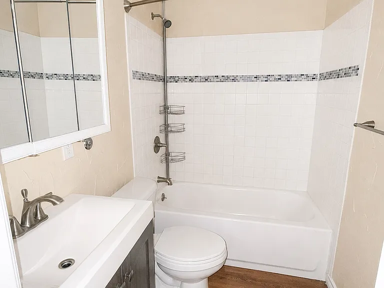 Updated full bathroom featuring modern fixtures and a tiled shower/tub combination.