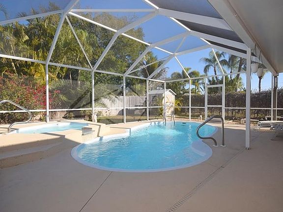 Pool with pour over spa and screen enclosure