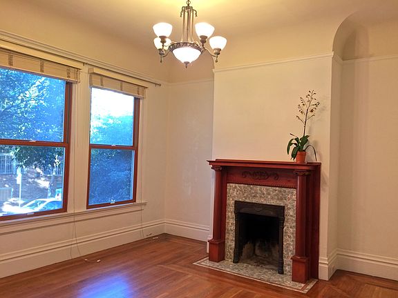 Living room with original showpiece fireplace.