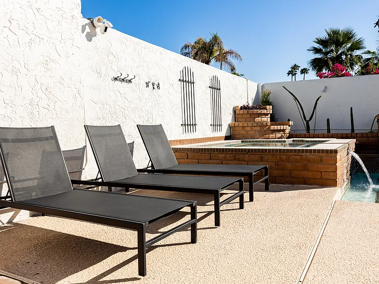 Outdoor lounge chairs by the hot tub. Front patio