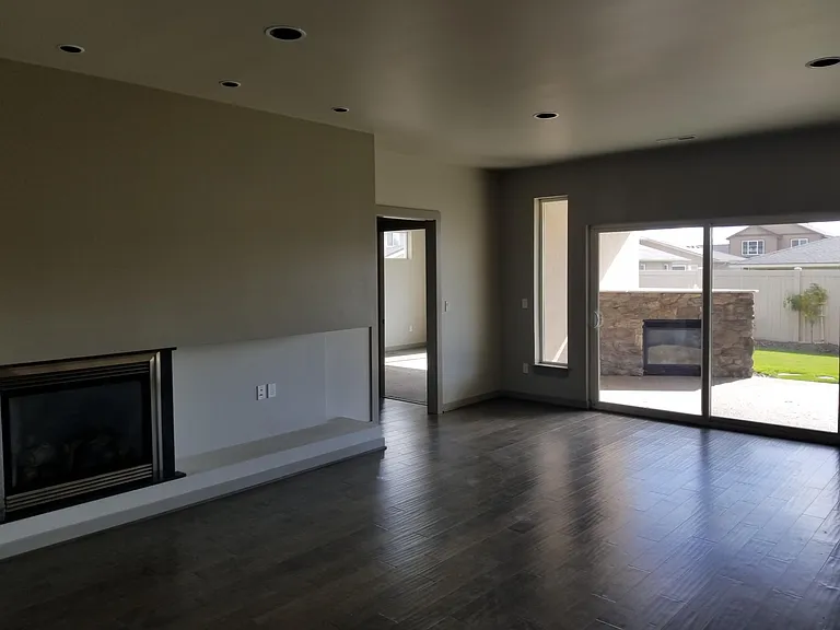 Great room with gas fire place, patio leads to outdoor gas fireplace under cover.
