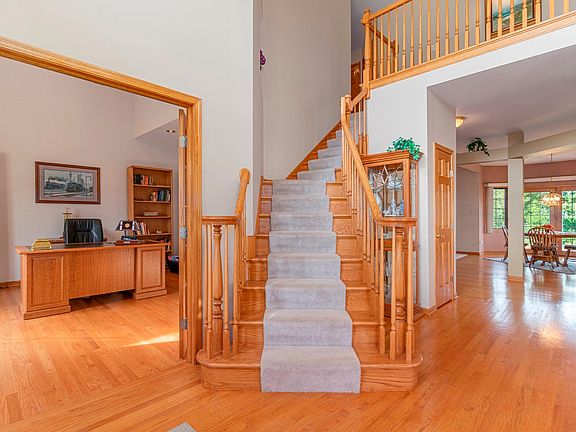 A stunning two-story open staircase in the foyer w