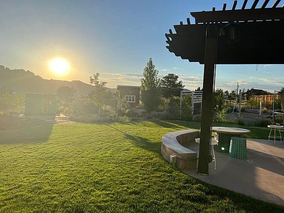 Full landscaped back yard. Fenced in (small digs negotiable.) Yard has numerous fruit trees, tool shed, playhouse, greenhouse, and in ground garden. There is also a massive sandbox/play area.