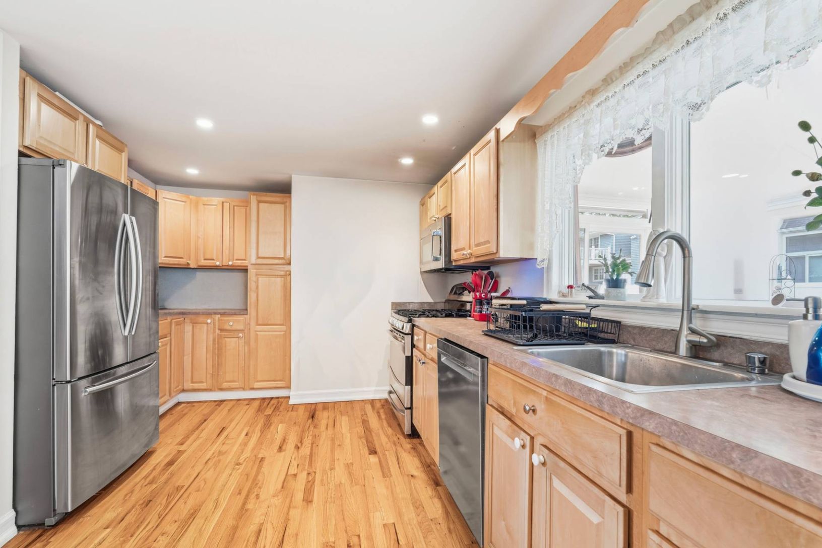 Chefs kitchen with stainless steel appliances and plenty of oak cabinetry