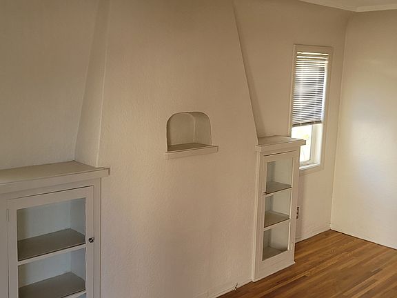 Living room with Hardwood floors and built in cabinets