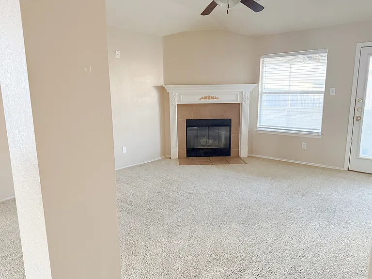 Family Room with fireplace and ceiling fan.