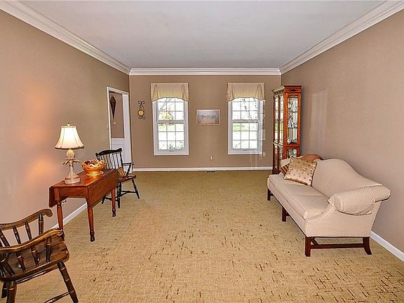 Off the entry is a formal living room with crown molding.