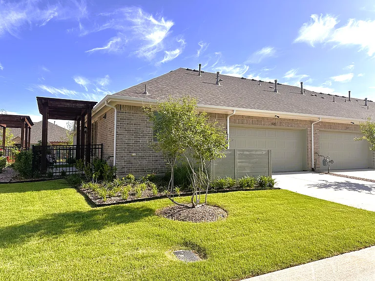 View of back of property with two car garage