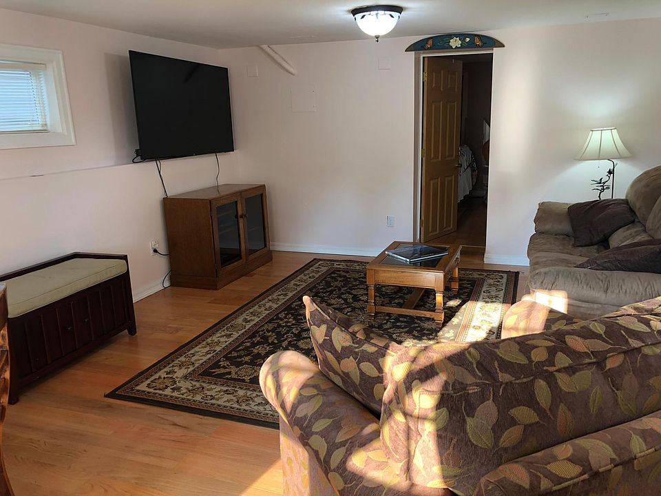 Living Room with 65 inch Smart TV, italian leather sofa and dining area seating for four