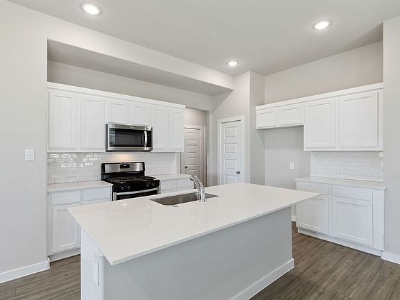 Kitchen in the Elm home plan by Trophy Signature Homes - REPRESENTATIVE PHOTO