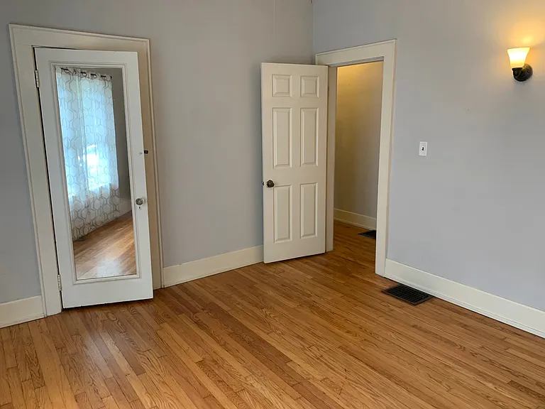 3rd bedroom with view of closet and hall