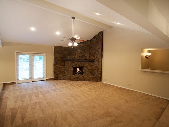 Large sunken family room w/ vaulted ceiling and wet bar