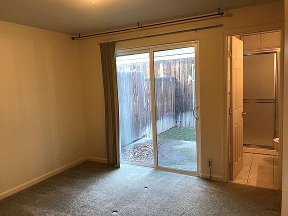 10 X 12 Master bedroom with glass doors to small outside patio.