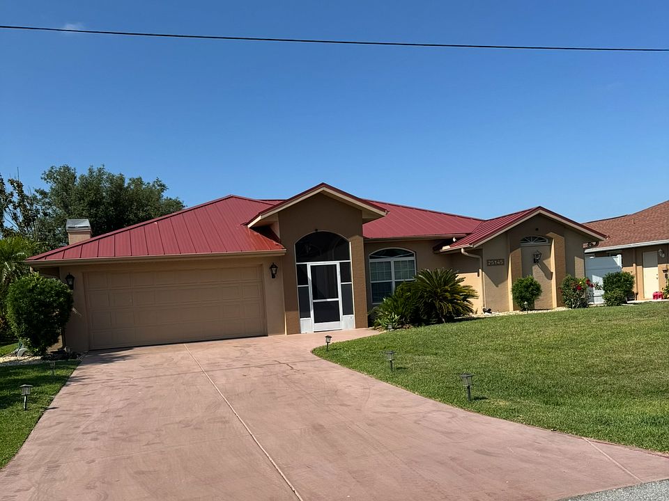 Beautiful Front of Home with Long Driveway and Attached Garage