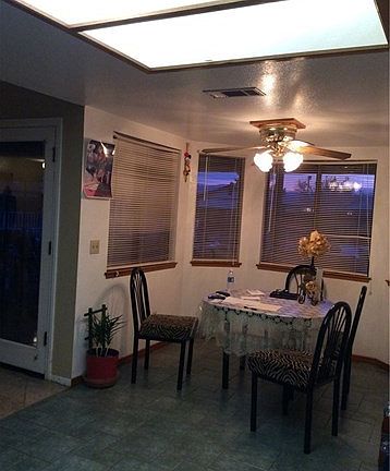 Dining area with view to back yard pool, and mountains.