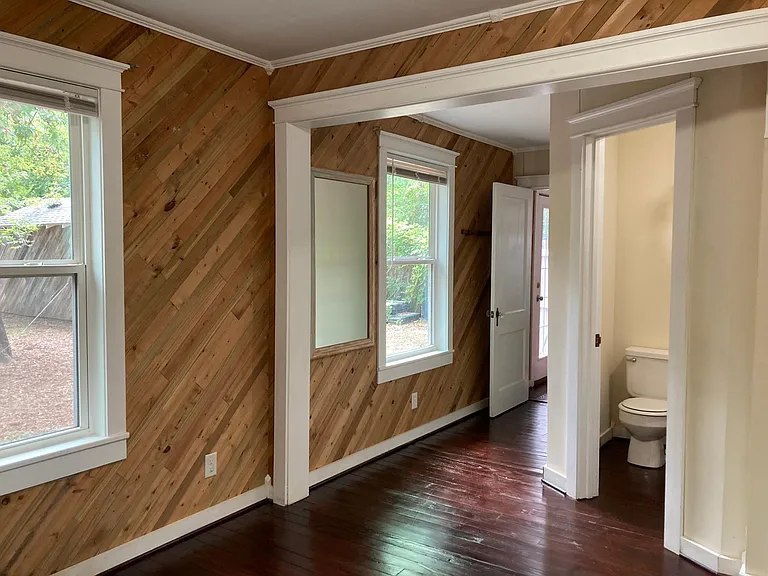 Bedroom #3 facing enclosed bathroom and exit into back hall