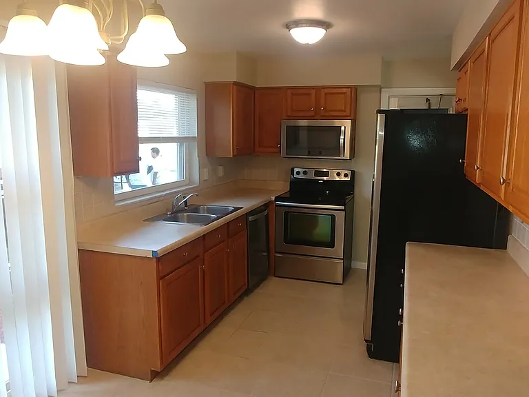 Looking into the kitchen w/an abundance of natural light.