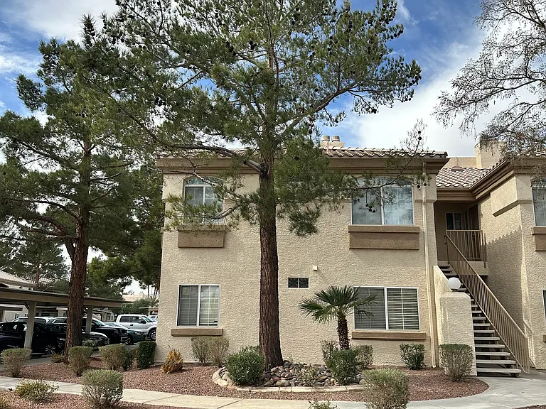 Overlooking well-kept sidewalks and professionally landscaped grounds, the second-floor view offers a peaceful green escape with mature trees.