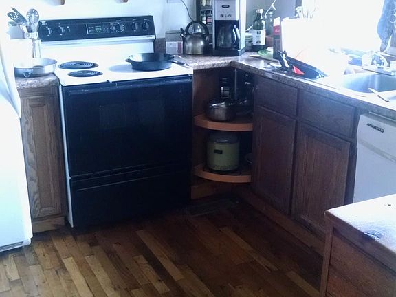 Kitchen with wood floors and natural wood wainscoat ceiling